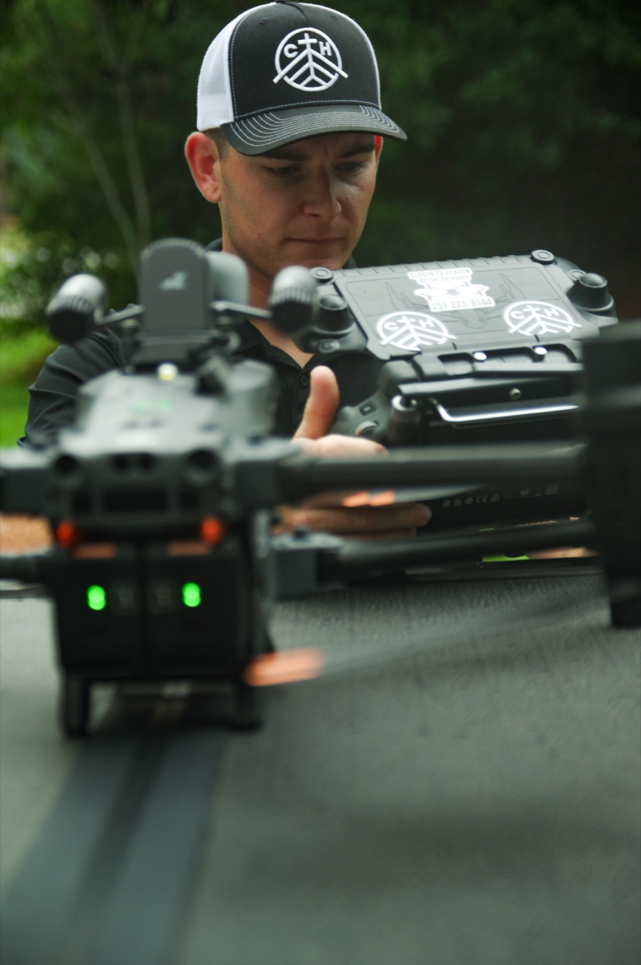 Brayden Biebricher, founder of Closer to Heaven LLC, preparing a drone