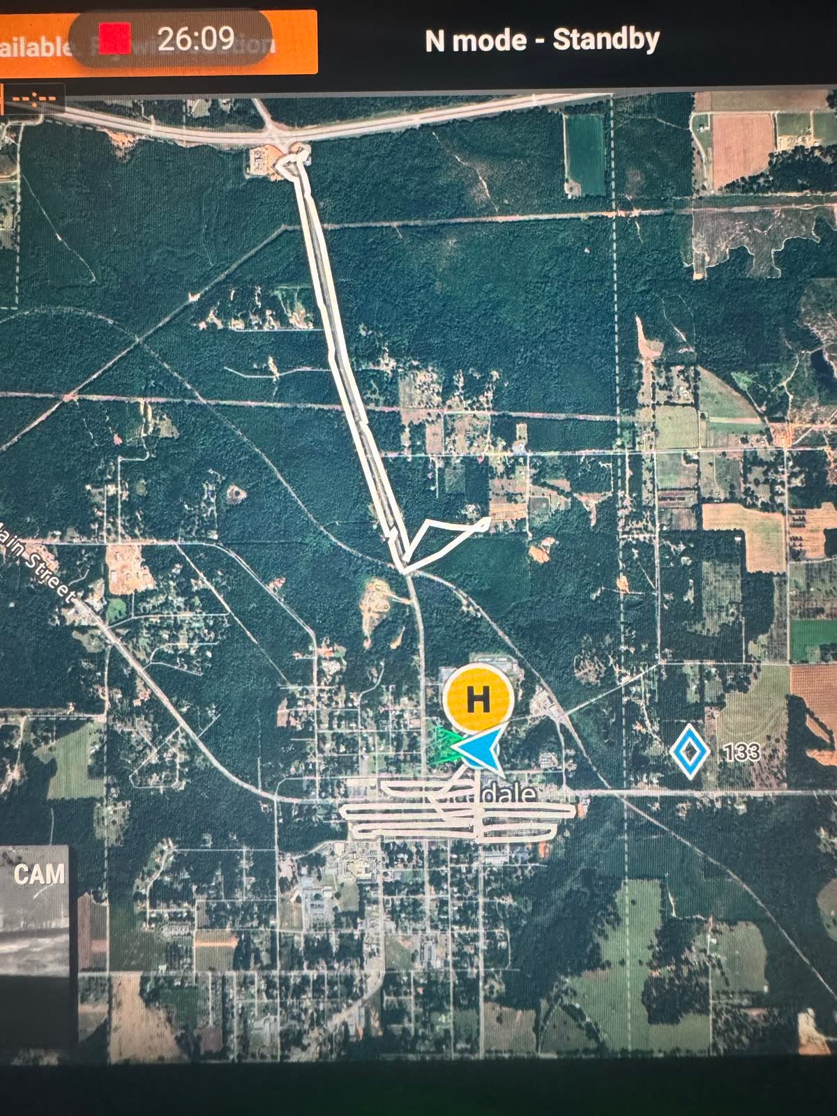 Drone controller screen showing a wide satellite view of the Lucedale search area with the flown track running north from the launch point